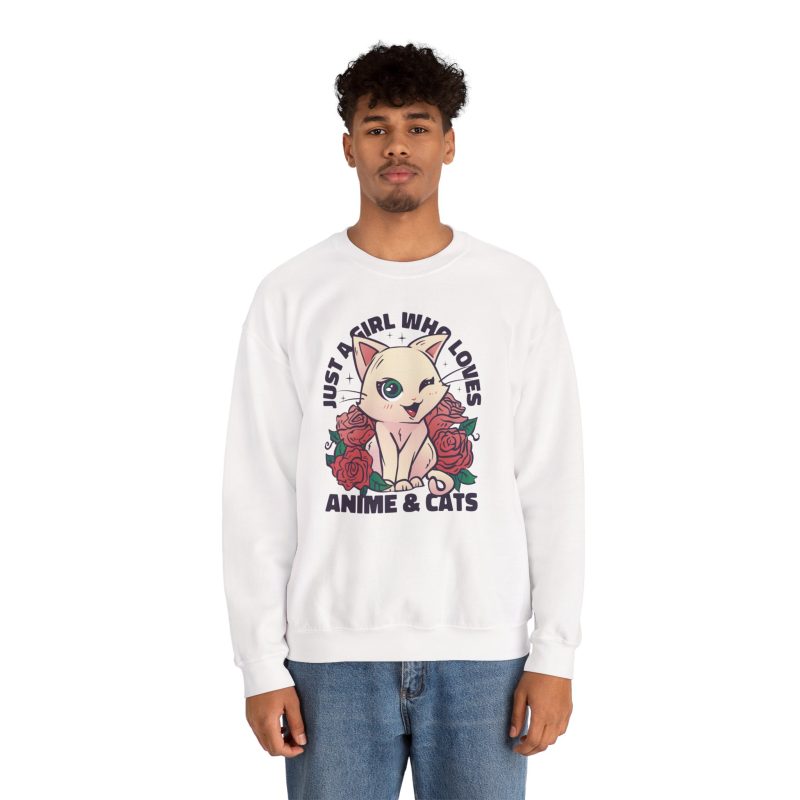 Person wearing a crewneck sweatshirt with a winking pale cream cat framed by red roses and green leaves printed on the front