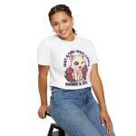 Person wearing a tee with a winking pale cream cat framed by red roses and green leaves printed on the front
