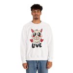 Person wearing a crewneck sweatshirt with a cream cat with glossy black eyes and red cheeks between two red hearts above black lettering printed on the front Person wearing a crewneck sweatshirt with a cream cat with glossy black eyes and red cheeks between two red hearts above black lettering printed on the front