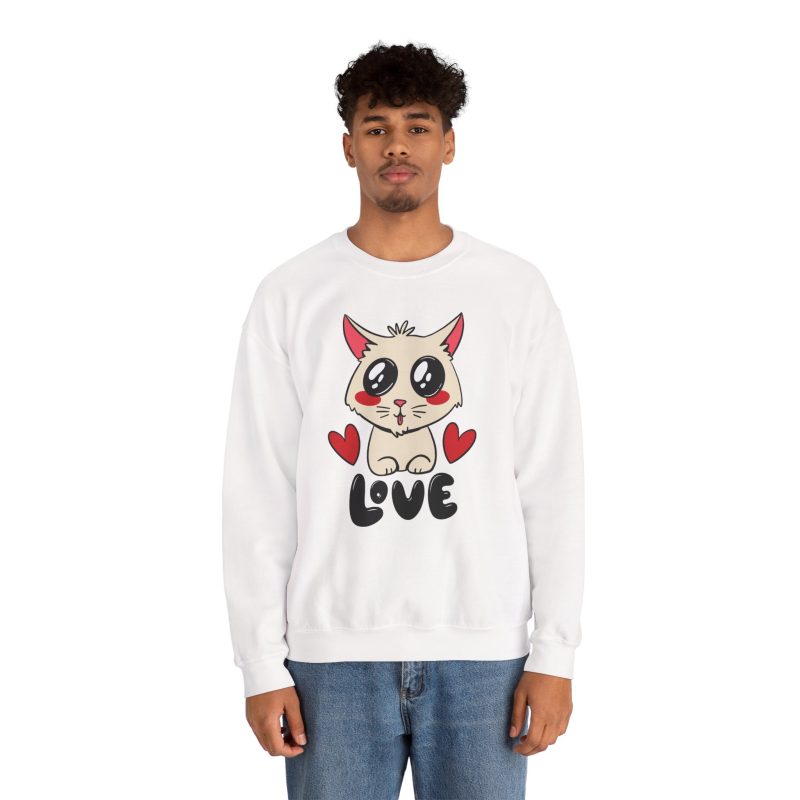 Person wearing a crewneck sweatshirt with a cream cat with glossy black eyes and red cheeks between two red hearts above black lettering printed on the front