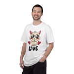 Person wearing a tee with a cream cat with glossy black eyes and red cheeks between two red hearts above black lettering printed on the front Person wearing a tee with a cream cat with glossy black eyes and red cheeks between two red hearts above black lettering printed on the front