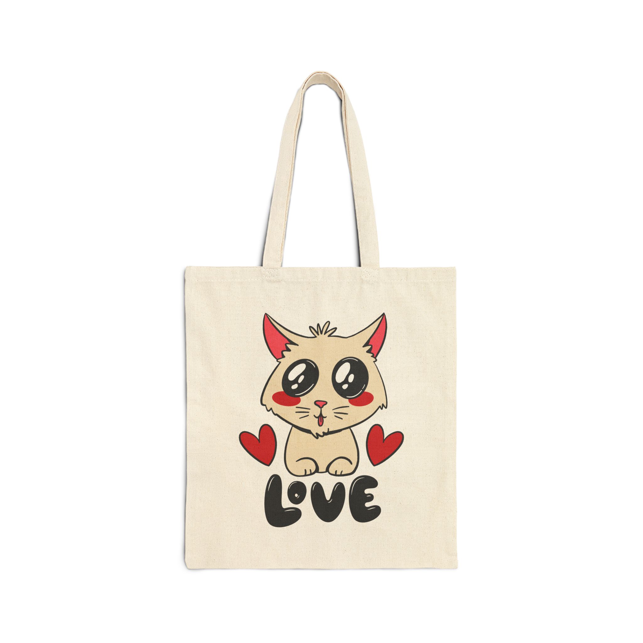 Front of the natural canvas tote showing a cream cat with glossy black eyes and red cheeks between two red hearts above black lettering