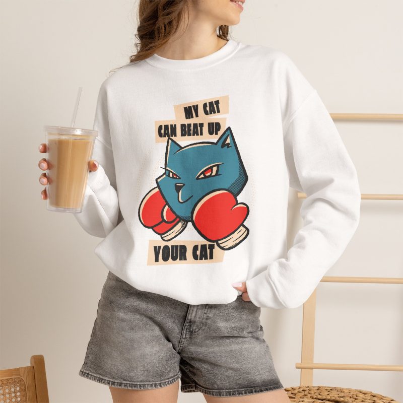 Person wearing a crewneck sweatshirt with a blue boxer cat with red gloves and a determined expression printed on the front