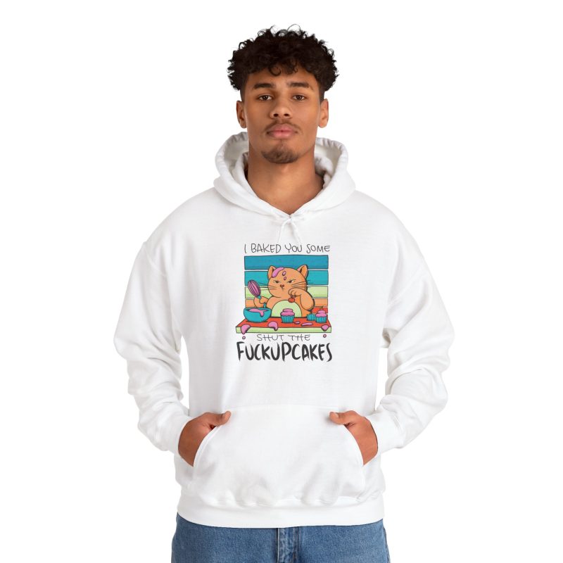 Person wearing a hoodie with a ginger baker cat with a pink whisk, cupcakes and turquoise retro stripes printed on the front