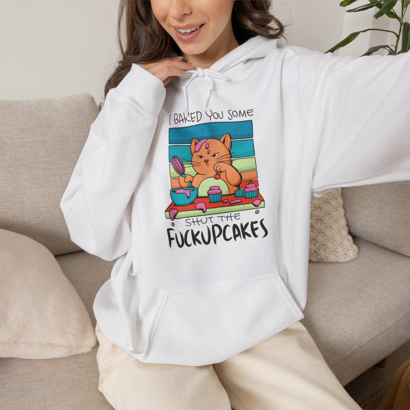 Person wearing a hoodie with a ginger baker cat with a pink whisk, cupcakes and turquoise retro stripes printed on the front