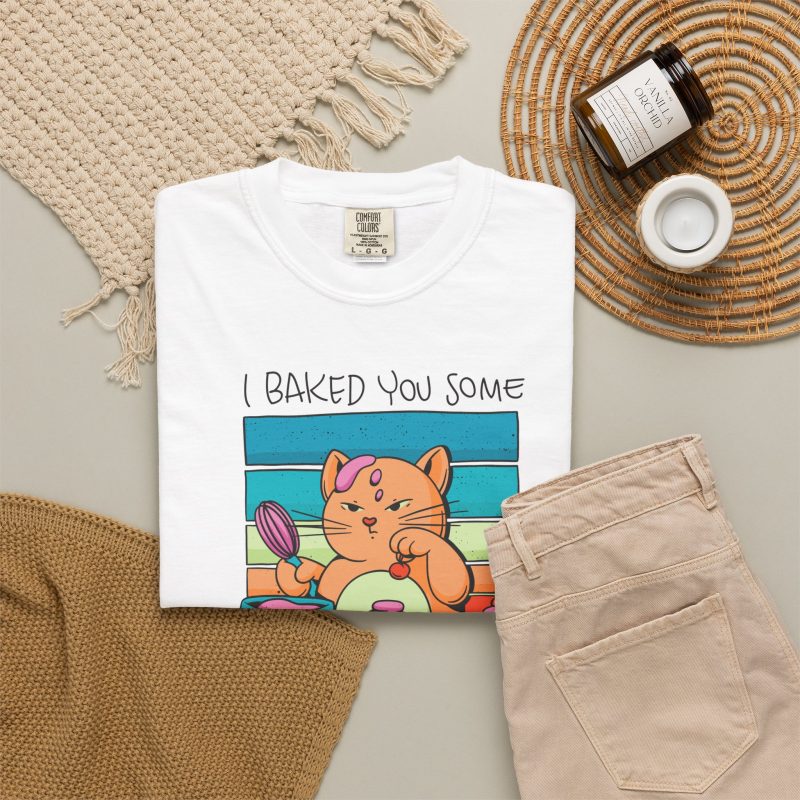 A ginger baker cat with a pink whisk, cupcakes and turquoise retro stripes in the front print