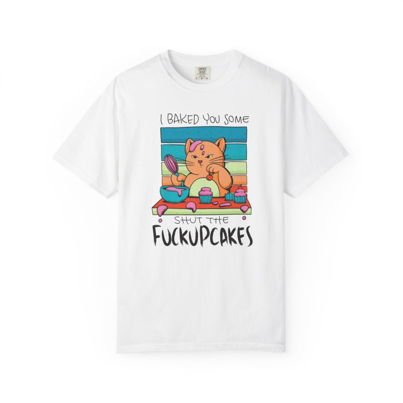 Front of the tee showing a ginger baker cat with a pink whisk, cupcakes and turquoise retro stripes