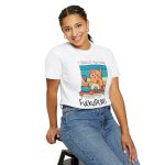 Person wearing a tee with a ginger baker cat with a pink whisk, cupcakes and turquoise retro stripes printed on the front Person wearing a tee with a ginger baker cat with a pink whisk, cupcakes and turquoise retro stripes printed on the front