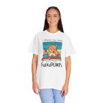 Person wearing a tee with a ginger baker cat with a pink whisk, cupcakes and turquoise retro stripes printed on the front Person wearing a tee with a ginger baker cat with a pink whisk, cupcakes and turquoise retro stripes printed on the front