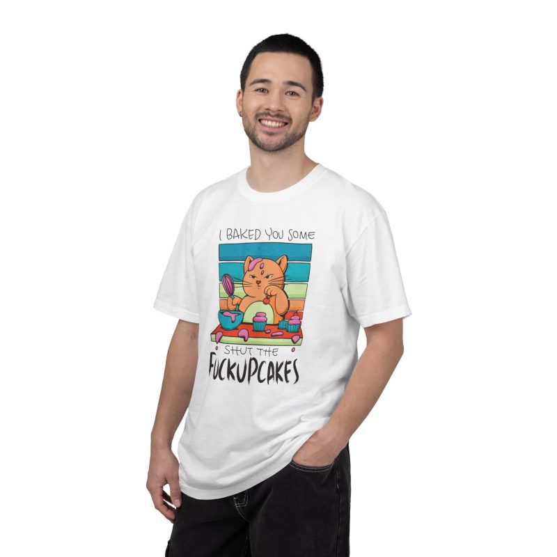 Person wearing a tee with a ginger baker cat with a pink whisk, cupcakes and turquoise retro stripes printed on the front