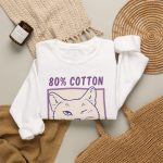 A winking white cat drawn in blue inside a cream square with purple lettering in the front print A winking white cat drawn in blue inside a cream square with purple lettering in the front print