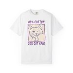 Front of the tee showing a winking white cat drawn in blue inside a cream square with purple lettering