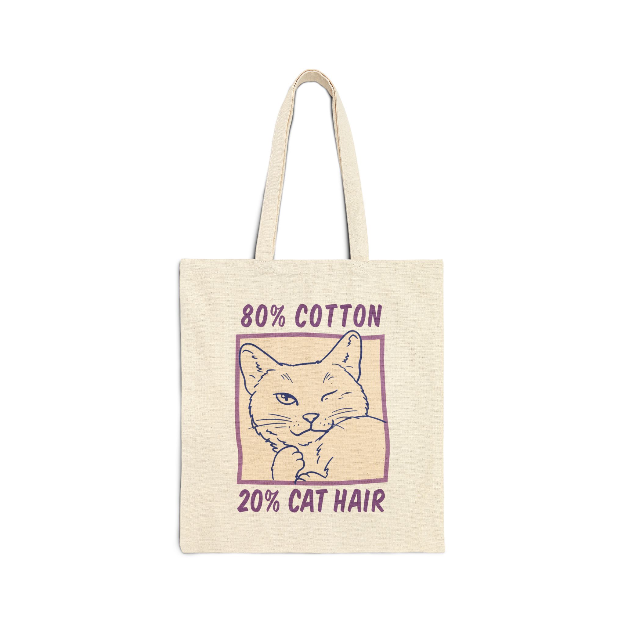 Front of the natural canvas tote showing a winking white cat drawn in blue inside a cream square with purple lettering