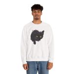 Person wearing a crewneck sweatshirt with an illustrated black cat with yellow-green eyes and a paw reaching through a gray torn-hole effect printed on the front