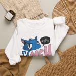 An unimpressed blue cat beside large pink lettering and a black comic speech bubble in the front print An unimpressed blue cat beside large pink lettering and a black comic speech bubble in the front print