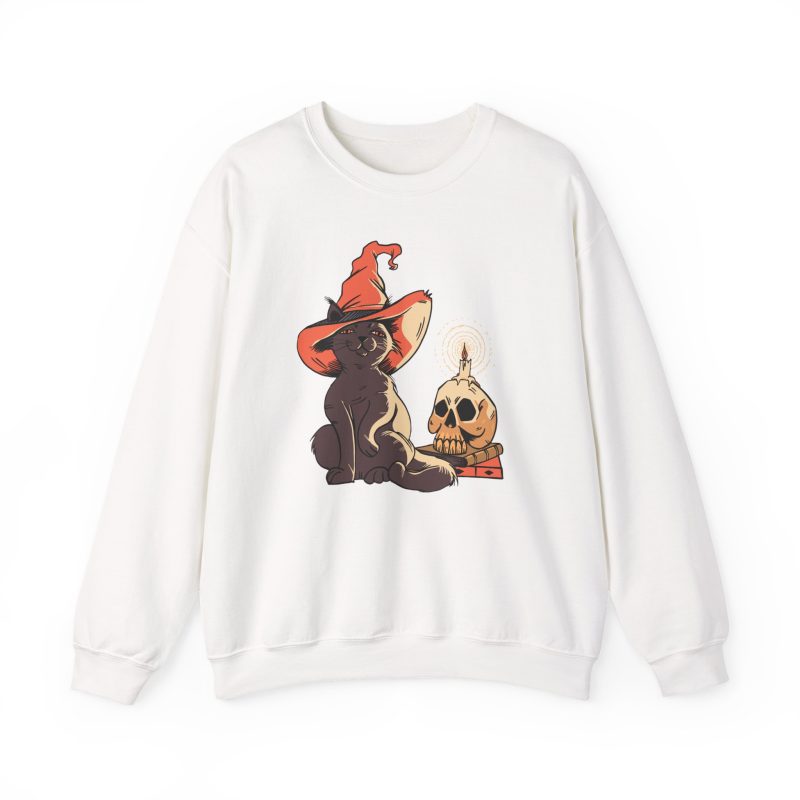 Front of the crewneck sweatshirt showing a brown cat in an orange witch hat beside a skull, lit candle and stacked spell books