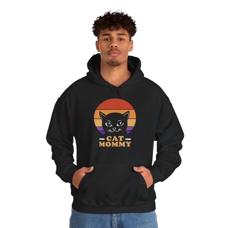 Person wearing a hoodie with a cat face inside red, orange and purple sunset stripes above warm orange lettering printed on the front