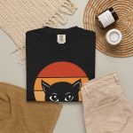 A cat face inside red, orange and purple sunset stripes above warm orange lettering in the front print