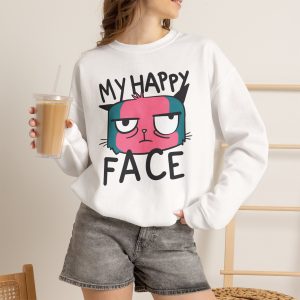 Person wearing a crewneck sweatshirt showing a pink and teal cat face and black lettering on the front