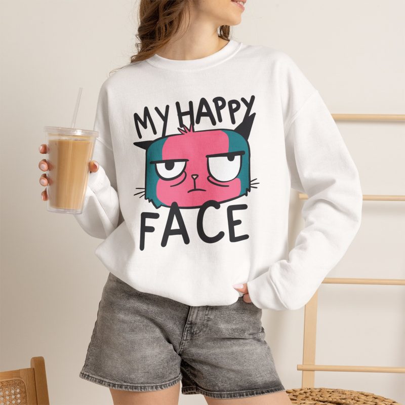 Person wearing a crewneck sweatshirt showing a pink and teal cat face and black lettering on the front