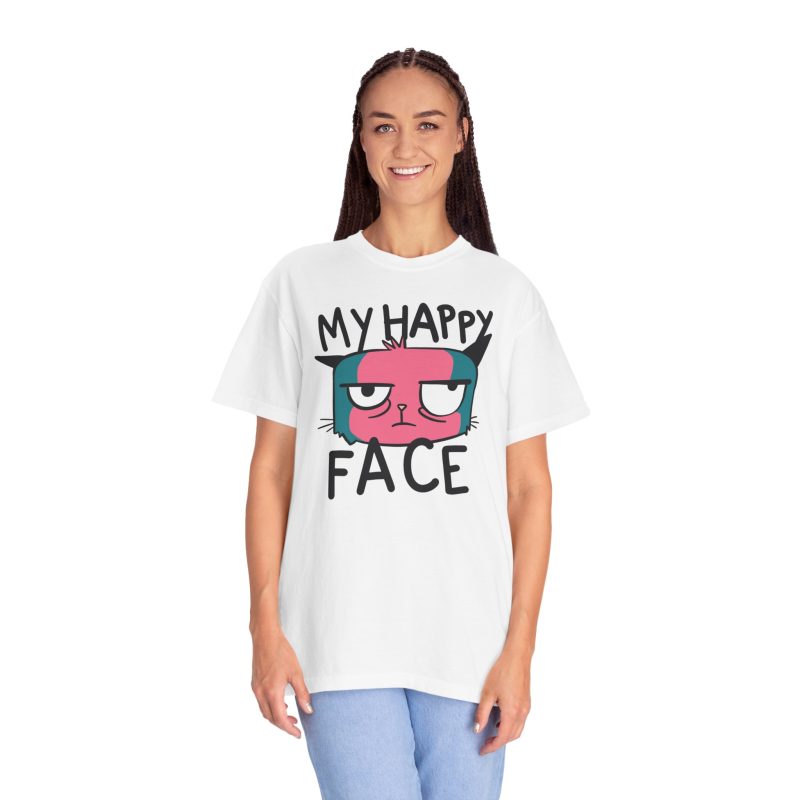 Person wearing a tee showing a pink and teal cat face and black lettering on the front