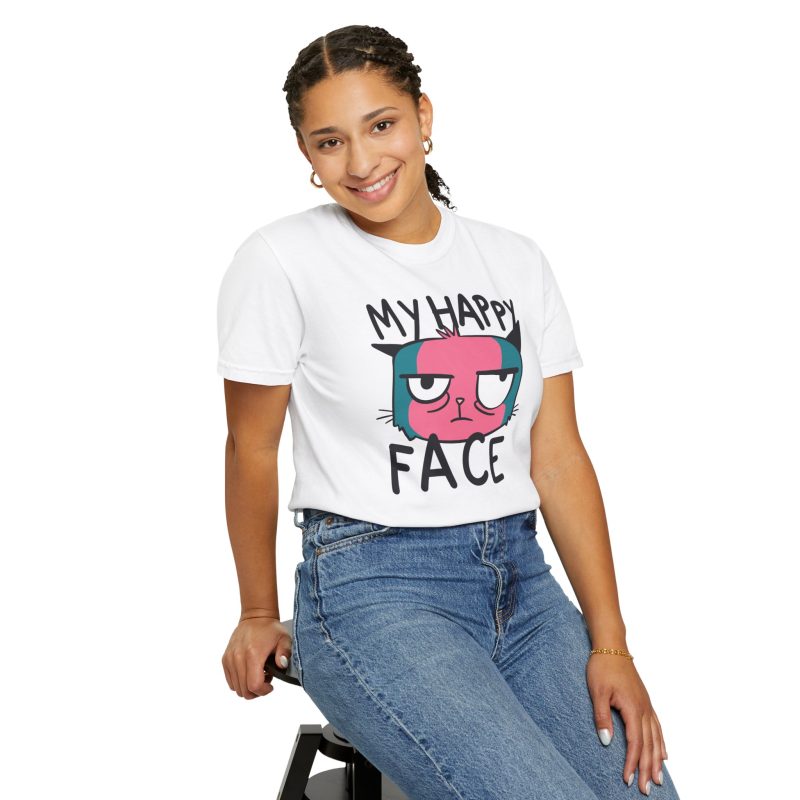 Person wearing a tee showing a pink and teal cat face and black lettering on the front
