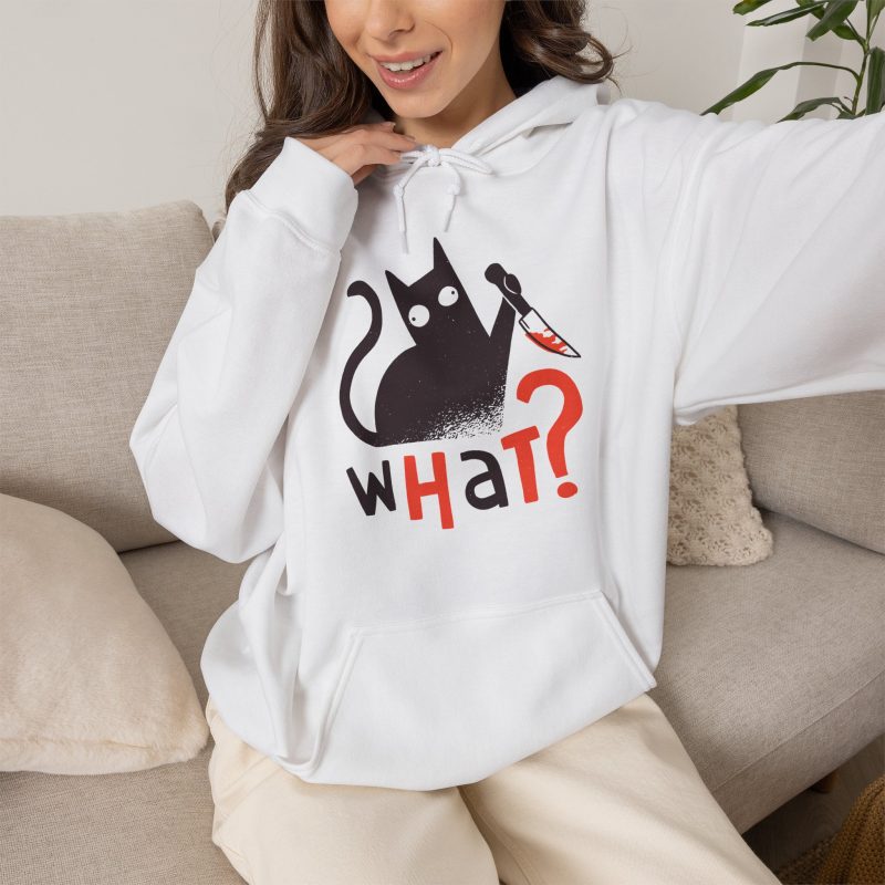 Person wearing a hoodie showing a wide-eyed black cat with a kitchen knife and black and orange lettering on the front