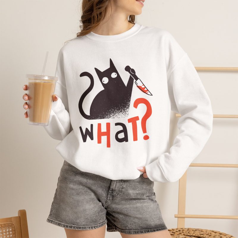 Person wearing a crewneck sweatshirt showing a wide-eyed black cat with a kitchen knife and black and orange lettering on the front