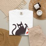 Wide-eyed black cat with a curled tail and kitchen knife beside black and orange WHAT? lettering in the front print