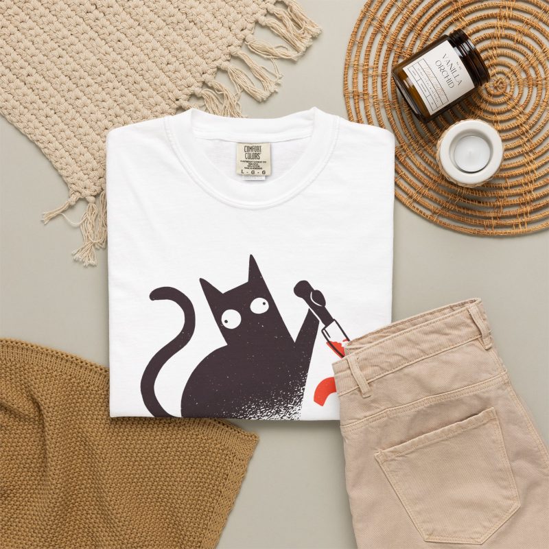 Wide-eyed black cat with a curled tail and kitchen knife beside black and orange WHAT? lettering in the front print