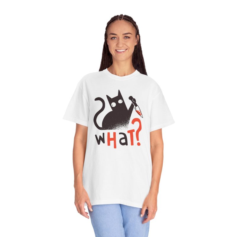 Person wearing a tee showing a wide-eyed black cat with a kitchen knife and black and orange lettering on the front