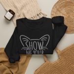 Gray Show Me Your Kitties hand lettering framed by pointed cat ears and whiskers in the front print