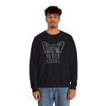 Person wearing a crewneck sweatshirt showing gray cat-ear and whisker lettering on the front