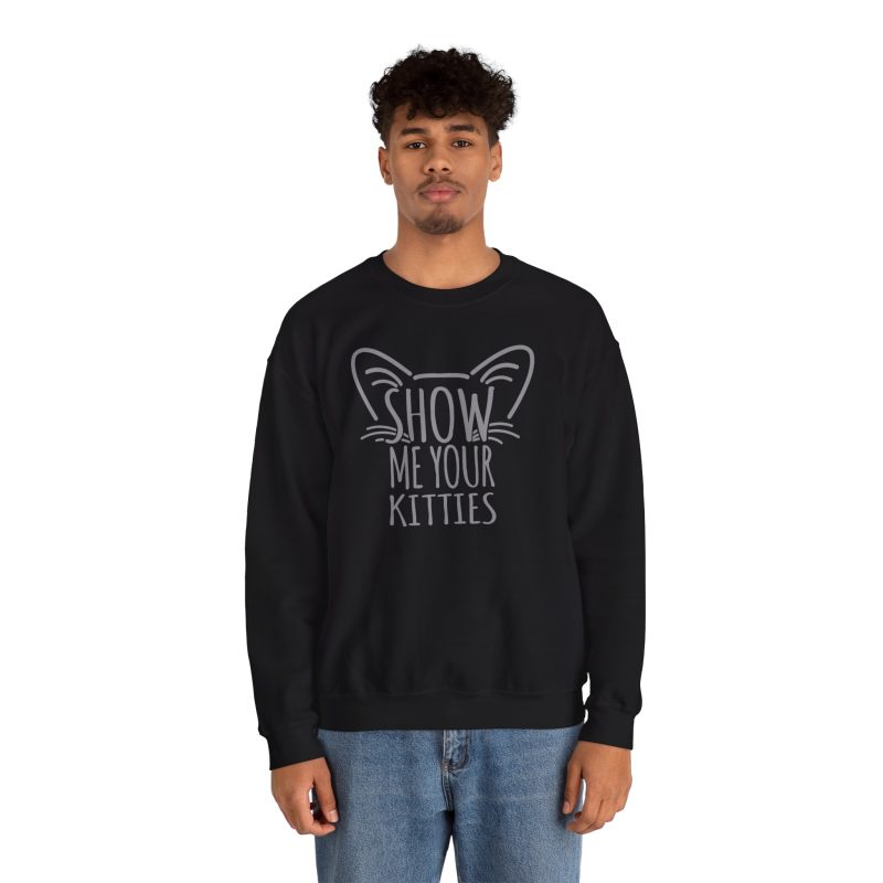 Person wearing a crewneck sweatshirt showing gray cat-ear and whisker lettering on the front