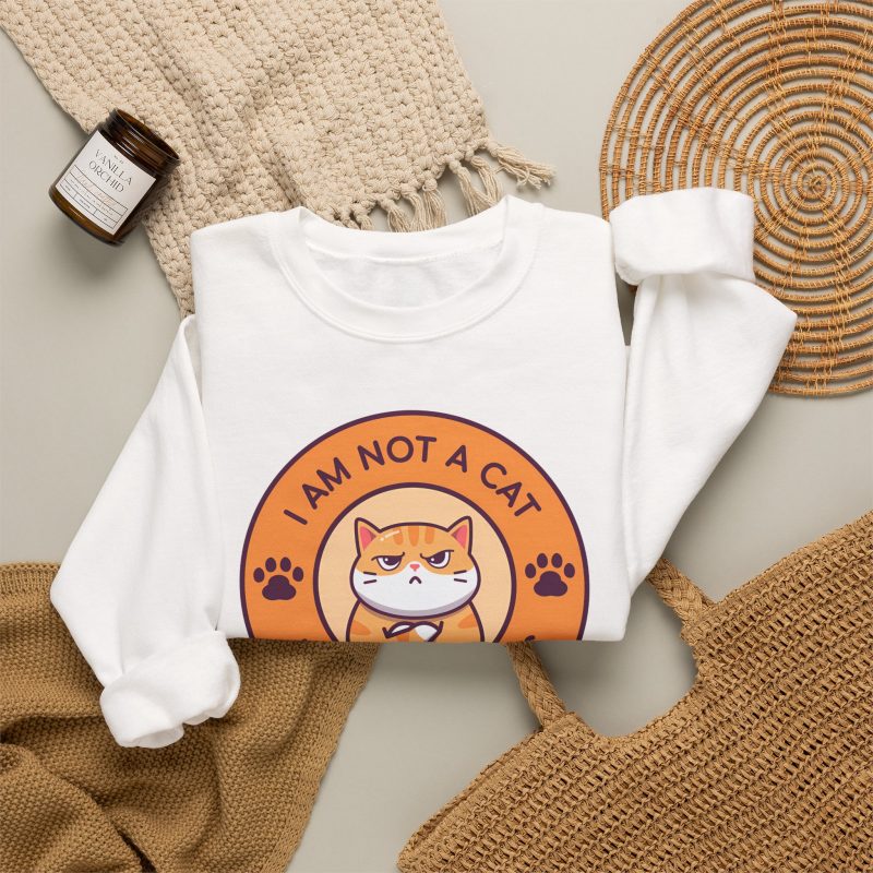 Ginger tabby with crossed arms, purple paw prints and I AM NOT A CAT - I AM YOUR BOSS lettering around an orange badge in the front print