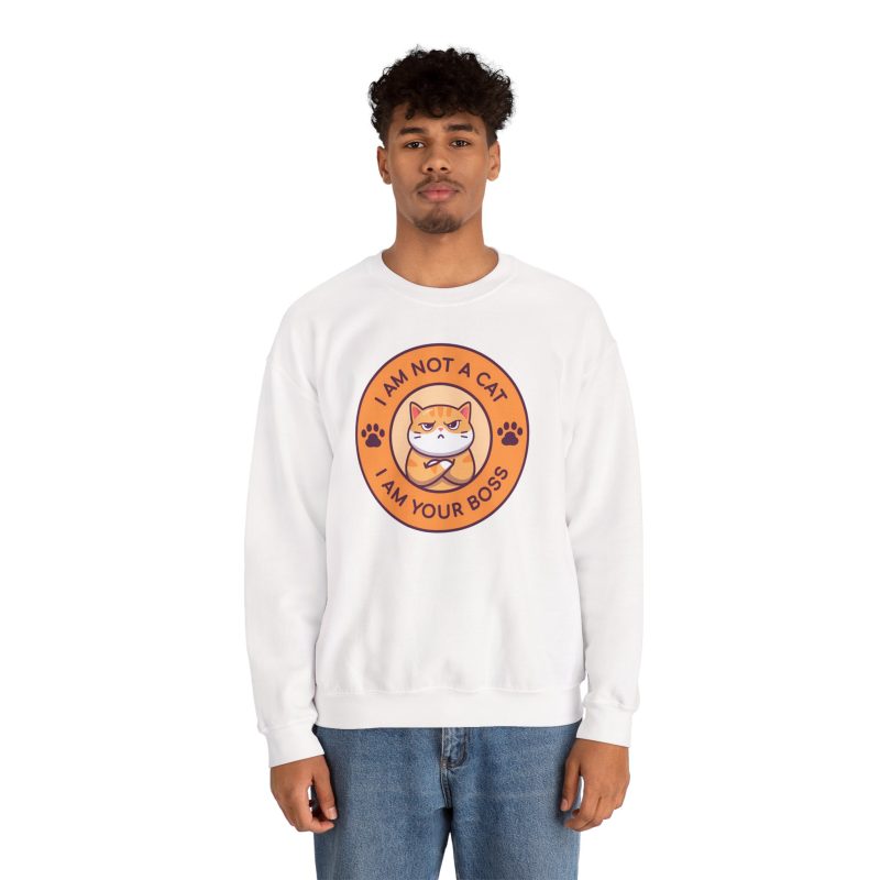 Person wearing a crewneck sweatshirt with an unimpressed ginger tabby with crossed arms inside an orange badge with dark purple lettering and two paw prints printed on the front