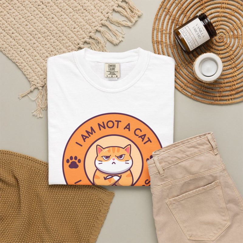 Ginger tabby with crossed arms, purple paw prints and I AM NOT A CAT - I AM YOUR BOSS lettering around an orange badge in the front print