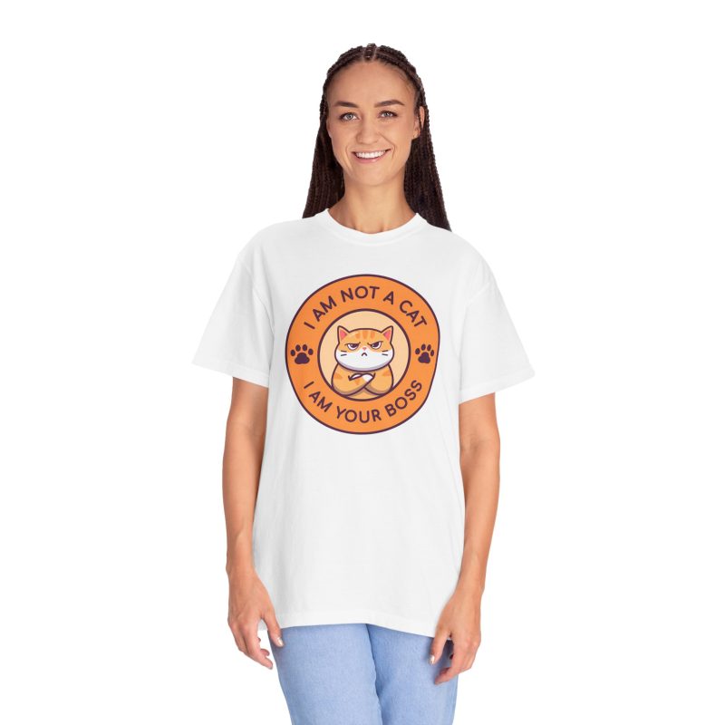 Person wearing a tee with an unimpressed ginger tabby with crossed arms inside an orange badge with dark purple lettering and two paw prints printed on the front