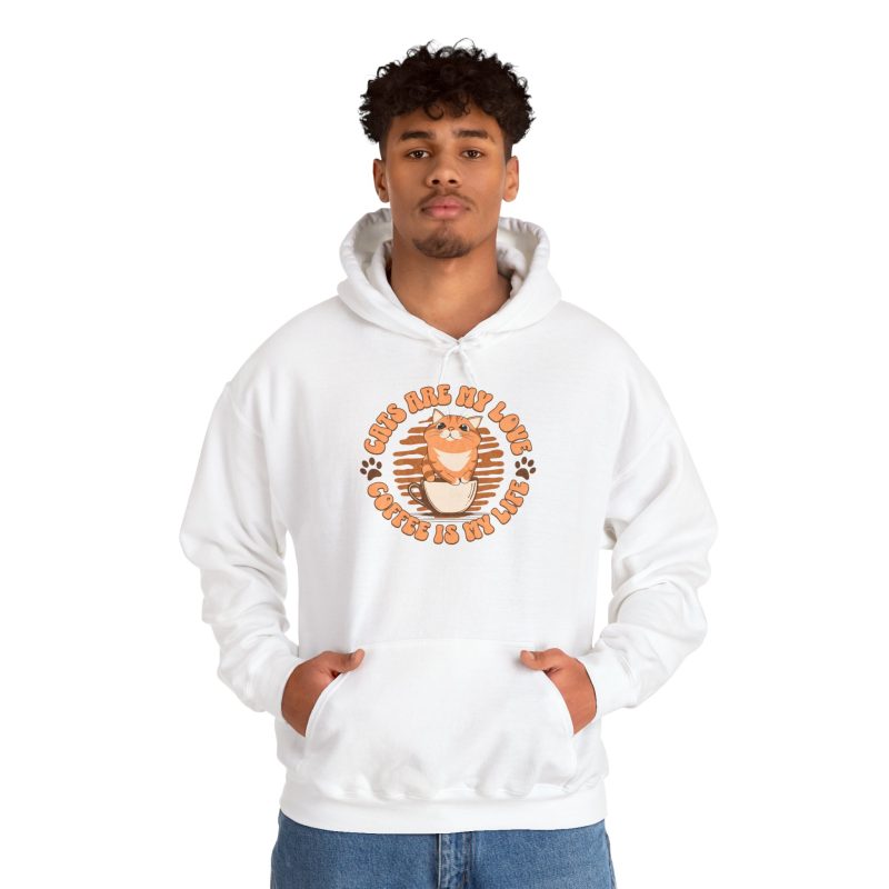 Person wearing a white hoodie with an orange tabby and coffee graphic above the front pocket