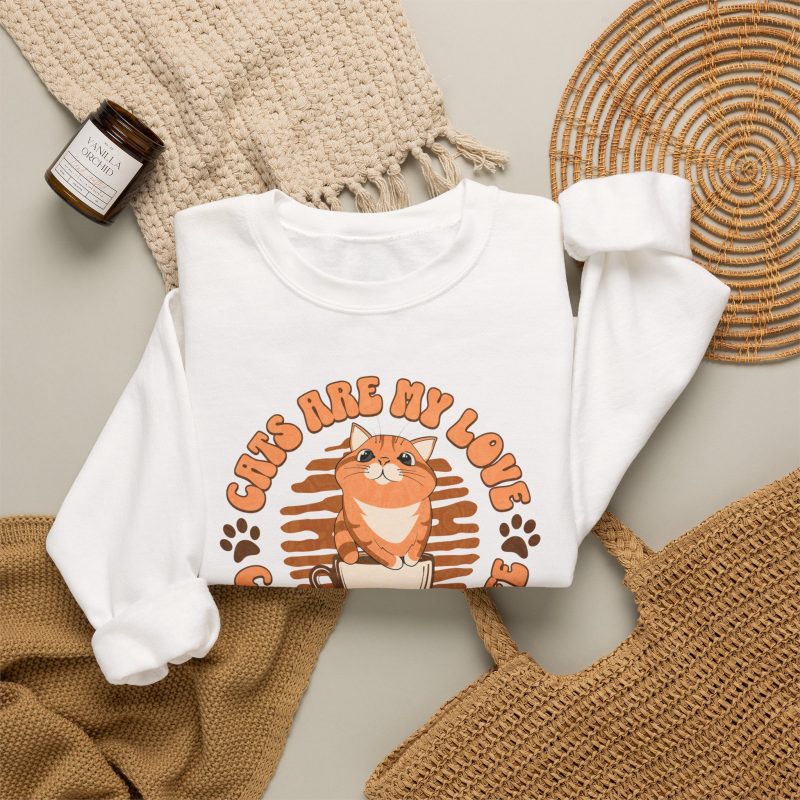 Detail of the sweatshirt's orange tabby, cream coffee cup and circular Cats Are My Love lettering