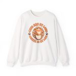 Front of a white cat sweatshirt with an orange tabby in a coffee cup and paw prints