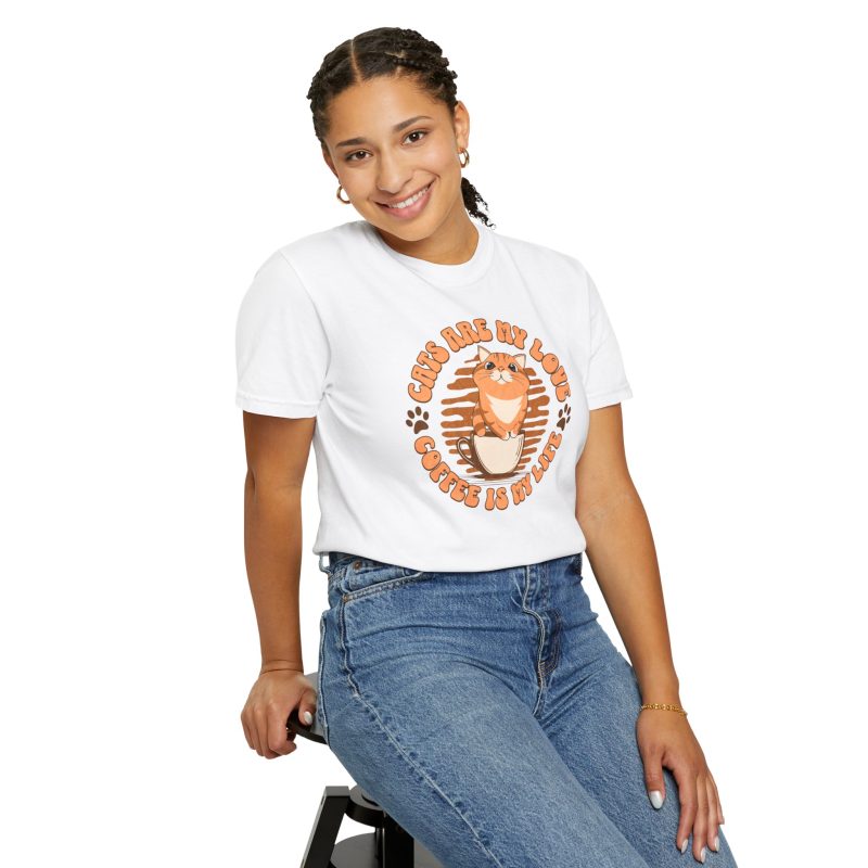 Person wearing a white tee with an orange tabby in a coffee cup printed on the front