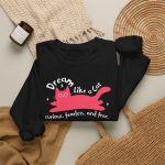 Pink reclining cat, white sparkles and curved Dream Like a Cat lettering in the front print