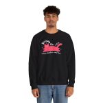 Person wearing a crewneck sweatshirt with a pink reclining cat with a raised tail, round eyes and white sparkles printed on the front
