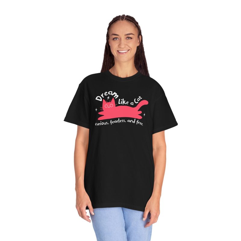Person wearing a tee with a pink reclining cat with a raised tail, round eyes and white sparkles printed on the front