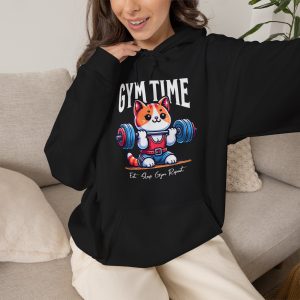 Person wearing a hoodie with an orange-and-white kitten lifting a barbell with blue and pink weight plates printed on the front