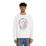 Person wearing a crewneck sweatshirt with a cat reclining in a hammock between filing cabinets with blue lettering and red paw prints printed on the front