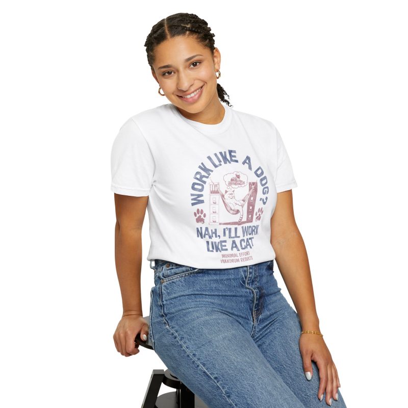 Person wearing a tee with a cat reclining in a hammock between filing cabinets with blue lettering and red paw prints printed on the front