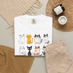 Eight line-drawn cats with assorted coat patterns above Purrfect Love lettering in the front print