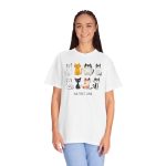 Person wearing a tee with eight line-drawn cats in two rows with different expressions and coat patterns printed on the front